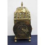 A 20th Century brass lantern clock, of typical form and bearing pseudo date '1699', Roman dial,