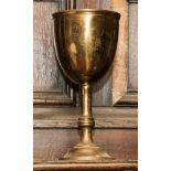 A lead weighted brass chalice or goblet,
