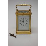 A Hall and Co French carriage clock, made in Paris, four pillared movement, white enamelled dial,