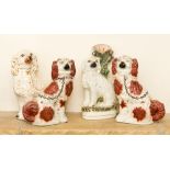 Four Staffordshire flatback dogs, including a pair of brown spotted spaniels and two others,