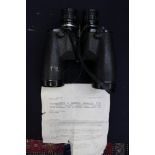 A pair of Tasco 200m coated binoculars with typed order confirmation, circa,