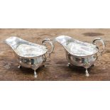 A pair of Victorian silver sauce boats, George II style with open acanthus C scroll handles,