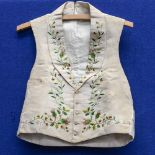 An 1870s gentlemen's waistcoat in beige grosgrain, machine embroidered heavily on front,