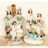 Four Staffordshire flatback figure groups, including fish woman and man, woman on horse,
