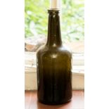 An 18th Century glass wine bottle, green glass, shouldered mallet form,