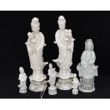 A pair of early 20th Century Guanyin deities - blanc de chine and four further blanc de chine