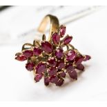 A 9ct gold multi tiered ruby ring claw set with marquise and round rubies,