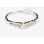A diamond solitaire ring, 9ct white gold ring, with diamond set shoulders,