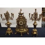 A cast brass German mantle clock and garniture,