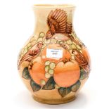 A Moorcroft vase depicting sparrows, apricots and grapes, with orange and brown palette, WM to base,