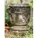 A large stone vase planter, twin handled form, carved in relief with putti riding dolphins,