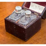 A cased box containing two scent bottles,