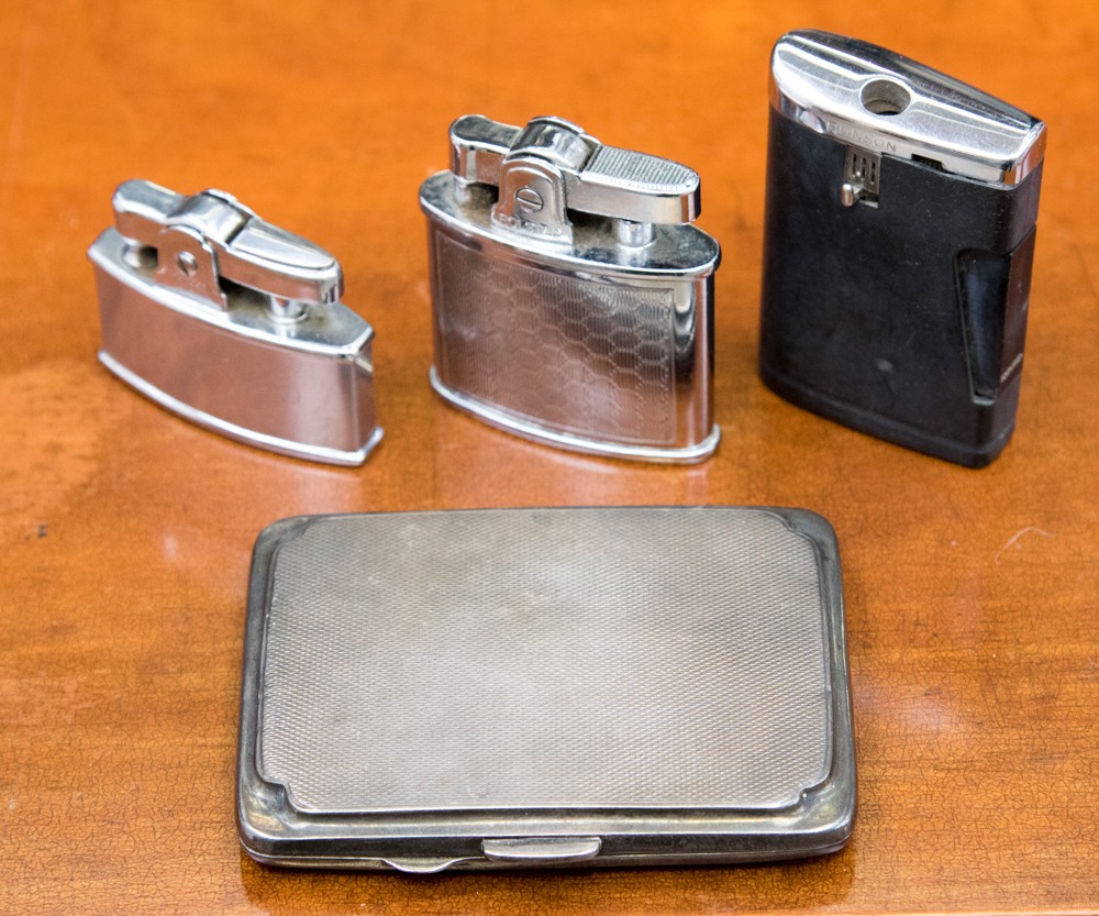 A silver pocket cigarette case, Birmingham 1939, Joseph Gloster and three pocket lighters,