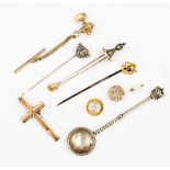 A collection of gold and silver jewellery including a yellow metal cross pendant,