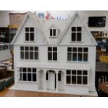 A wooden, repainted , but unfurnished dolls house, approx 91cms width, 82cms high,