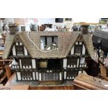 A large Tudor style dolls house, approx 127cms wide, 90cms Hight, 58cms depth,