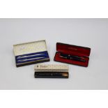 A Parker slim fold (navy case) 14k nib banding together with matching propelling pencil,