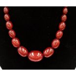 A cherry amber type necklace with graduated oval beads,