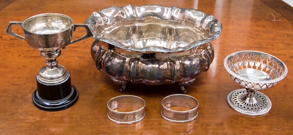 A silver trophy cup on plastic pedestal, Sheffield 1960 with two silver napkin rings,