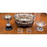 A silver trophy cup on plastic pedestal, Sheffield 1960 with two silver napkin rings,