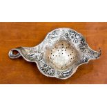 A sterling silver Art Nouveau tea strainer,