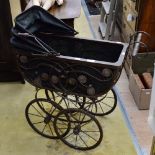 A wirework and canvas dolls pram