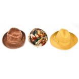 A mustard coloured felt ladies trilby with a mid brown felt ladies trilby and a feathered fitted
