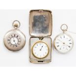 A silver cased travel clock with engine turned case detail, white enamel dial, a/f missing hand,