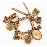 A 9ct gold charm bracelet with ten various 9ct gold and base metal charms,