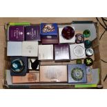 A box containing a collection of assorted glass paperweights, including Caithness glass,