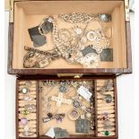 A brown leather covered jewellery box with assorted white metal and silver jewellery, rings,