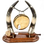 An oak mounted gong, brass gong supported by a pair of horns in EPNS mounts,
