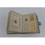 A Victorian photograph album with some photographs