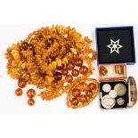 A collection of amber and amber type necklaces with various shaped beads, cufflinks,