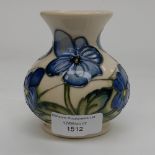 A squat bulbous Moorcroft vase, pansy/violas pattern, having blue flowers on cream ground,