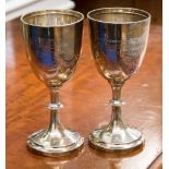 A pair of silver goblets with engraving to fronts, Chester hallmarked 1912, weight 8.