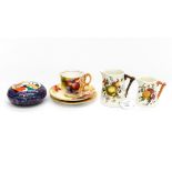 A Royal Worcester fruit painted coffee cup trio, signed Kitty Blake,