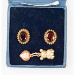 A pair of 9ct gold and garnet oval stud earrings;