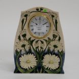 A Moorcroft clock in the Daisy May pattern.