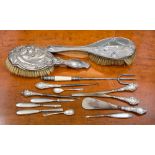 A group of silver handled ladies accoutrements including brushes, button hooks glove stretcher,