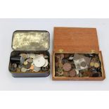 A tin and wooden box of various coins,