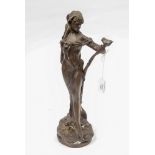 An Art Nouveau style bronze figure of a woman with flower, apparently unsigned,