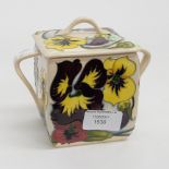 A Moorcroft twin handled biscuit box and cover in the Pansy pattern, on cream ground, 1st quality,
