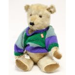 Chiltern: A 1950's blonde mohair teddy bear, orange glass eyes, black stitched nose, mouth and paws,