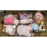 Five boxes of assorted, modern decorative dolls, most on stands.