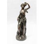 A large bronze figure of a woman with grapes,