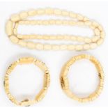 A collection of ivory jewellery including a flower detail carved bracelet,