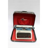 An Erika portable typewriter 1960s in carry case with spare cartridges/reels/ribbon and cleaning