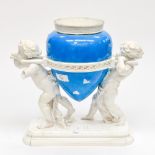 A continental vase, being carried by two putti, on plinth,