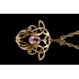 An Art Nouveau style pendant set with pink stone possibly topaz,